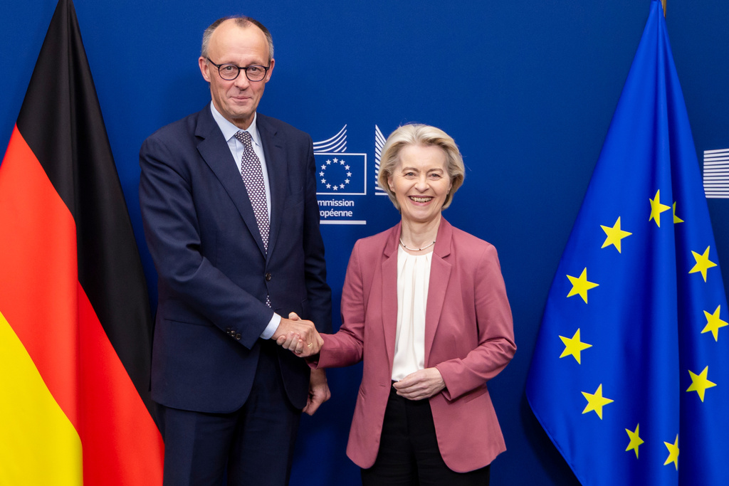 European Commission President Ursula von der Leyen, right, welcomes Germany's Chancellor Friedrich Merz at EU headquarters in Brussels, Friday, Dec. 5, 2025. (AP Photo/Geert Vanden Wijngaert)
