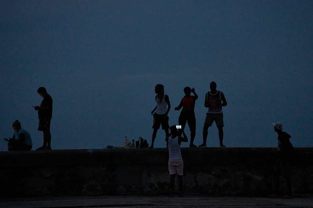 People spend time dancing on the Malecón seawall during a blackout in Havana, Cuba, Friday, July 10, 2026. (AP Photo/Ramon Espinosa)