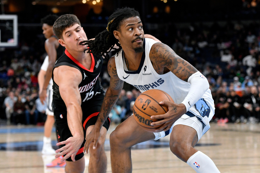 Memphis Grizzlies guard Ja Morant handles the ball against Houston Rockets guard Reed Sheppard (15) in the second half of an NBA basketball game Wednesday, Nov. 5, 2025, in Memphis, Tenn. (AP Photo/Brandon Dill)