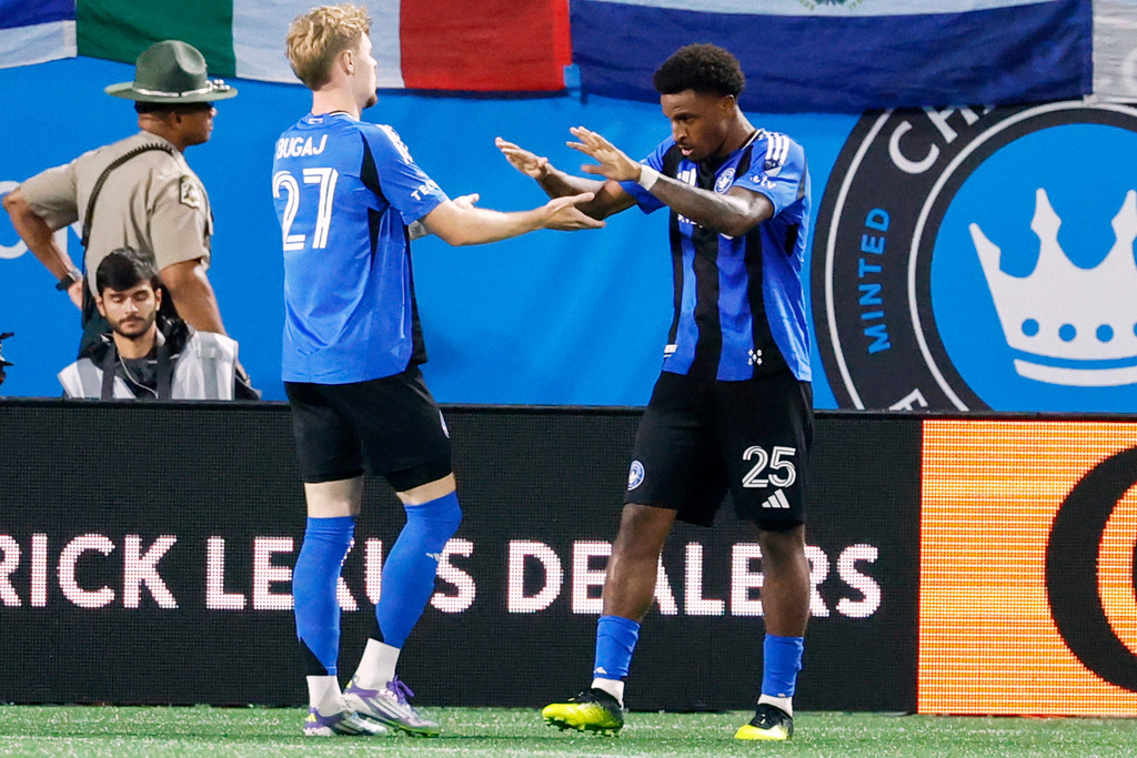 CF Montreal forward Dante Sealy (25) celebrates with defender Dawid Bugaj after Sealy scored against Charlotte FC during the second half of an MLS soccer match in Charlotte, N.C., Saturday, Sept. 27, 2025. (AP Photo/Nell Redmond)