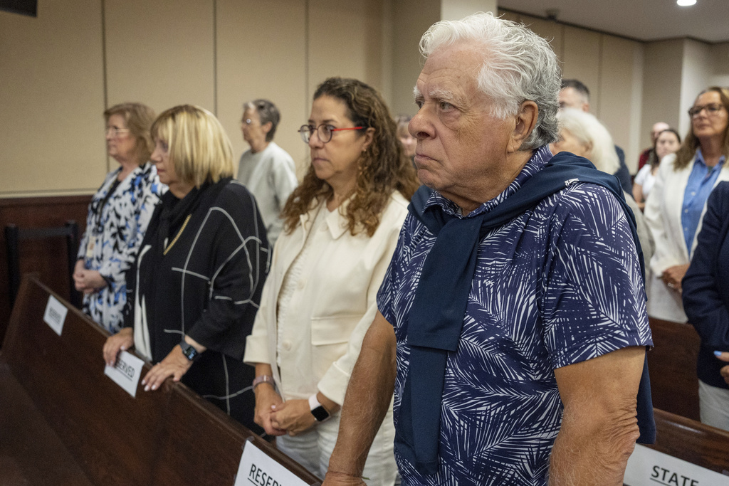 Phil Markel, right, and his family stand as jurors enter the courtroom for the trial of Donna Adelson on Friday, Aug. 22, 2025 in Tallahassee, Fla. (Alicia Devine/Tallahassee Democrat via AP, Pool)