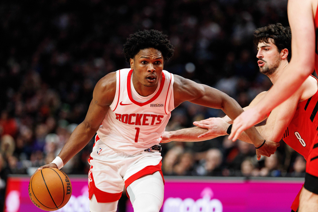 Houston Rockets guard Amen Thompson, left, dribbles against Portland Trail Blazers forward Deni Avdija, right. during the second half of an NBA basketball game Friday, Jan. 9, 2026, in Portland, Ore. (AP Photo/Howard Lao)