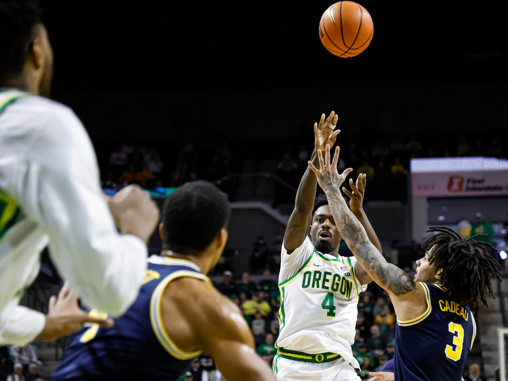 Oregon forward Dezdrick Lindsay (4) passes inside against (3) in the first half of an NCAA college basketball game in Eugene, Ore., Saturday, Jan. 17, 2026. (AP Photo/Thomas Boyd)