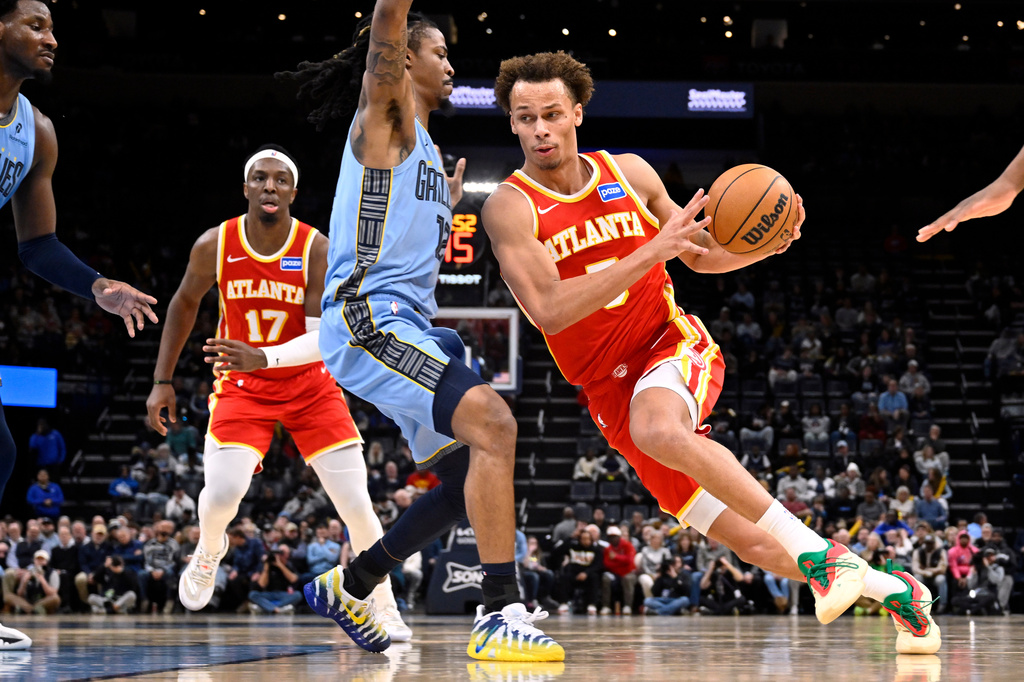 Atlanta Hawks guard Dyson Daniels (5) drives against Memphis Grizzlies guard Ja Morant (12) in the first half of an NBA basketball game Wednesday, Jan. 21, 2026, in Memphis, Tenn. (AP Photo/Brandon Dill)