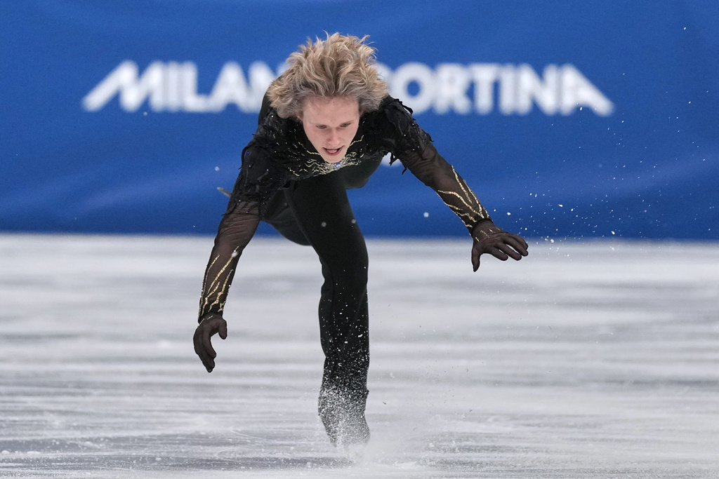 Ilia Malinin of the United States lands a back flip while competing during the figure skating men's team event at the 2026 Winter Olympics, in Milan, Italy, Sunday, Feb. 8, 2026. (AP Photo/Stephanie Scarbrough)