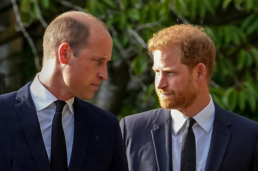 FILE - Britain's Prince William and Britain's Prince Harry walk beside each other after viewing the floral tributes for the late Queen Elizabeth II outside Windsor Castle, in Windsor, England on Sept. 10, 2022. (AP Photo/Martin Meissner, File)