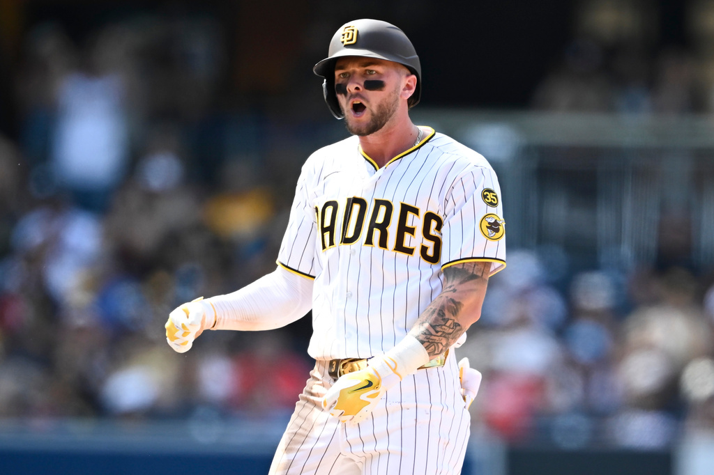 San Diego Padres' Jackson Merrill (3) celebrates after hitting a double during the eighth inning of a baseball game against the Cincinnati Reds Wednesday, June 10, 2026, in San Diego. (AP Photo/Denis Poroy)