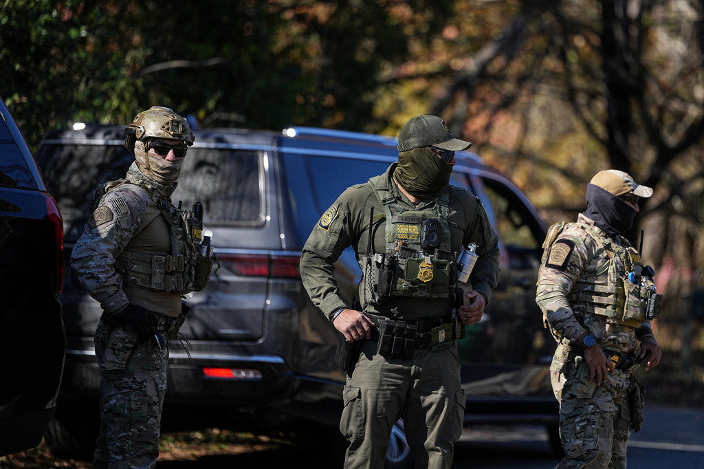 U.S. Border Patrol agents look on, Monday, Nov. 17, 2025, in Charlotte, N.C. (AP Photo/Matt Kelley)