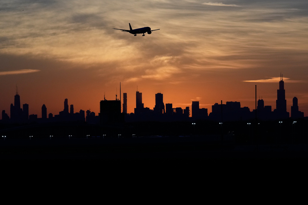 An airplane descends into landing at O'Hare International Airport in Chicago, Wednesday, Nov. 12, 2025. (AP Photo/Nam Y. Huh)