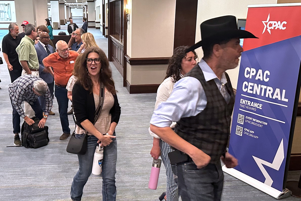Attendees wait in line to enter the Conservative Political Action Conference in Grapevine, Texas, Wednesday, March 25, 2026, as the annual gathering of thousands of conservatives from around the country and overseas begins. (AP Photo/Thomas Beaumont)