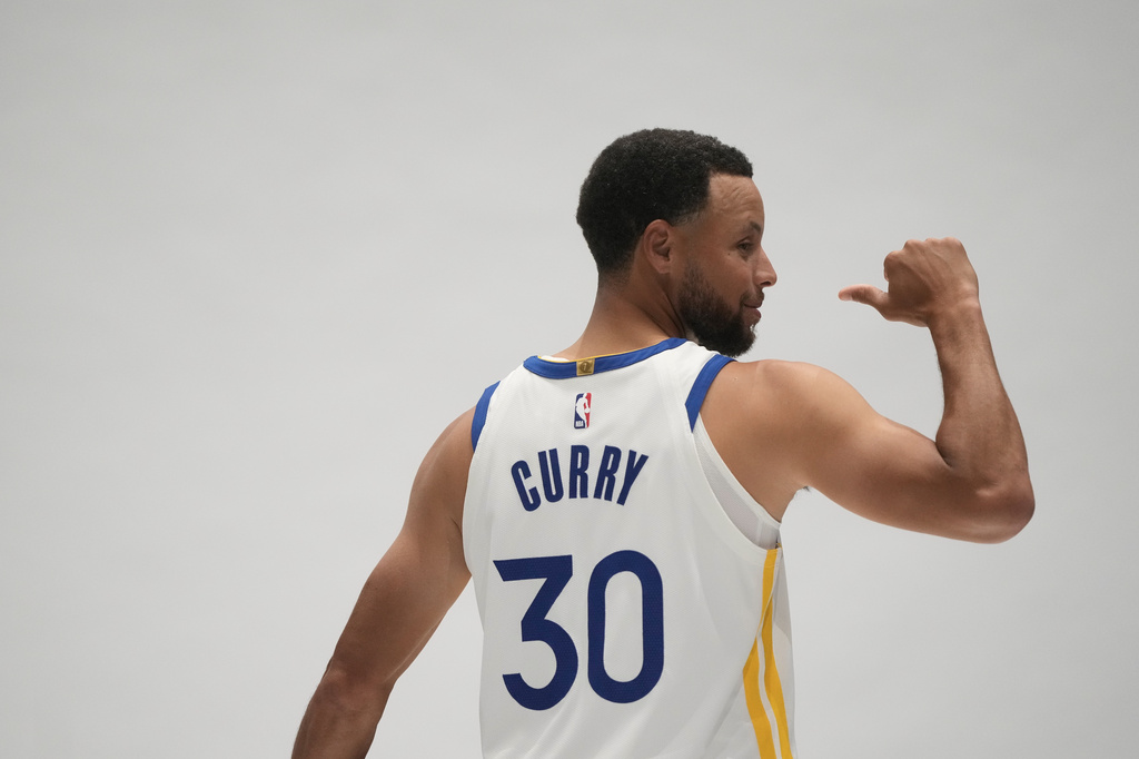 Golden State Warriors guard Stephen Curry poses for photos during the NBA basketball team's media day, Monday, Sept. 28, 2026, in San Francisco. (AP Photo/Jeff Chiu)