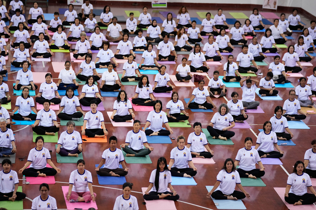 People take part in mass yoga programs to mark International Yoga Day organized by India Embassy Sunday, June 21, 2026, in Yangon, Myanmar. (AP Photo/Thein Zaw)