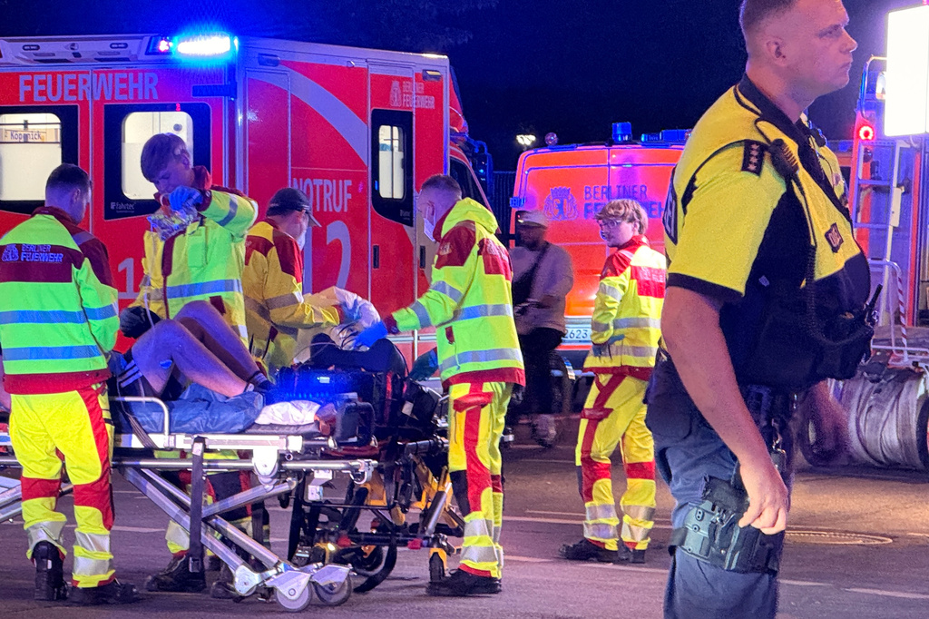 Emergency personnel tend to a person on a stretcher following the cancellation of Christopher Street Day in Berlin on Saturday, July 25, 2026. (Andreas Rabenstein/dpa via AP)