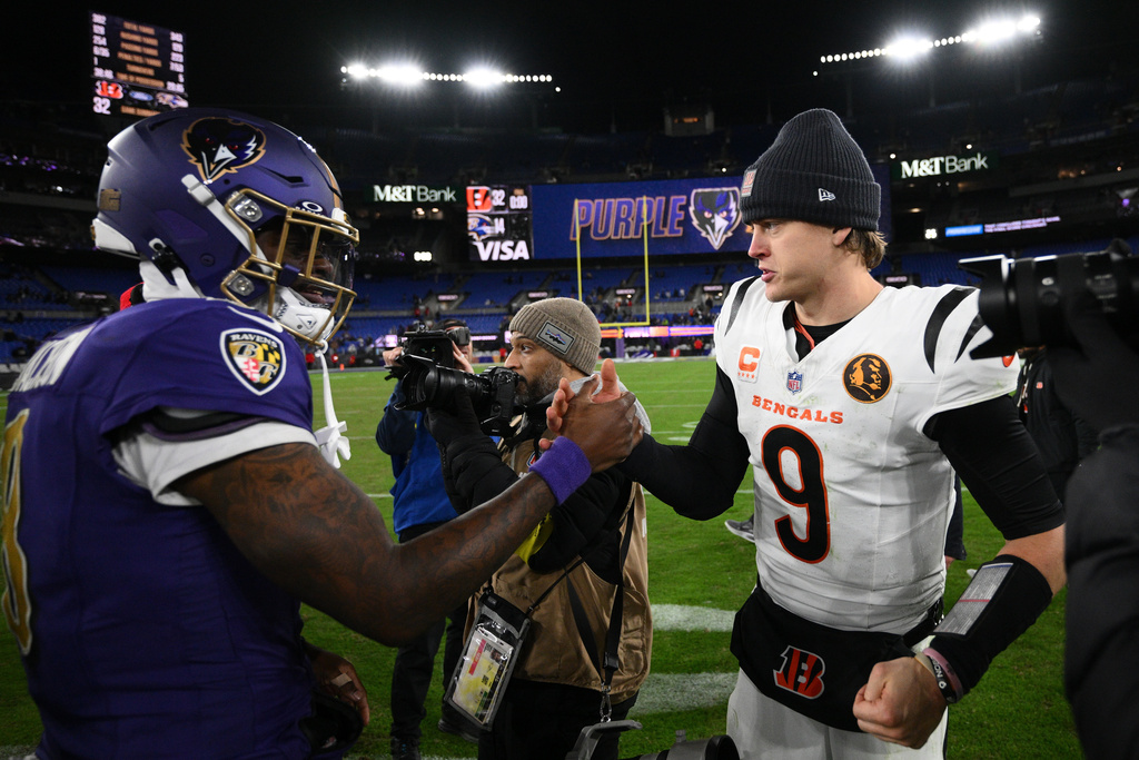 Baltimore Ravens quarterback Lamar Jackson (8) and Cincinnati Bengals quarterback Joe Burrow (9) greet each other after an NFL football game, Thursday, Nov. 27, 2025, in Baltimore. (AP Photo/Nick Wass)