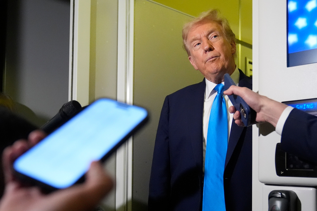 President Donald Trump listens to a question from a reporter aboard Air Force One at Al Udeid Air Base in Doha, Qatar, Saturday, Oct. 25, 2025. (AP Photo/Mark Schiefelbein)