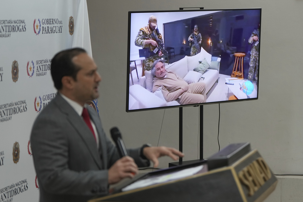 Paraguay's Anti-Drugs Secretary Jalil Rachid gives a news conference about the arrest of Mexico's alleged leader of “La Barredora” cartel, Hernan Bermudez Requena, whose image is on the screen, in Asuncion, Paraguay, Monday, Sept. 15, 2025. Bermudez was arrested in Paraguay on Sept. 12. (AP Photo/Jorge Saenz)