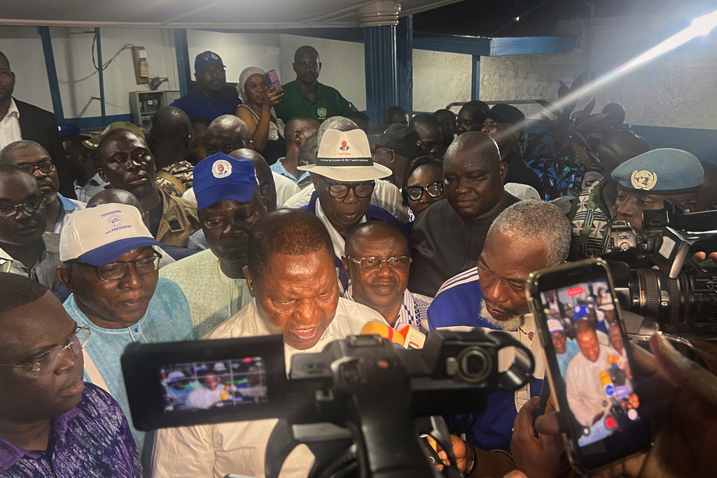 Central African Republic President Faustin Archange Touadéra, bottom center, speaks to the media after being declared the winner of the presidential election in Bangui, Central African Republic, Monday, Jan. 5, 2026. (AP Photo/Jean-Fernand Koena)