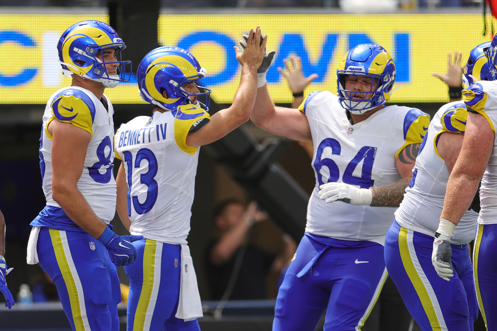 Los Angeles Rams quarterback Stetson Bennett (13) celebrates his rushing touchdown with teammates during the first half an NFL preseason football game against the New Orleans Saints Saturday, Aug. 22, 2026, in Inglewood, Calif. (AP Photo/Ryan Sun)