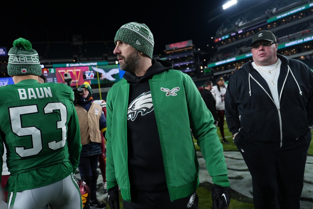 Philadelphia Eagles head coach Nick Sirianni leaves the field with Eagles head security official Dom DiSandro after an NFL football game against the Washington Commanders on Sunday, Jan. 4, 2026, in Philadelphia. (AP Photo/Matt Slocum)