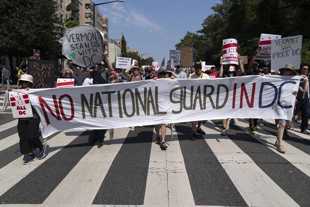 Demonstrators protest against President Donald Trump's deployment of federal law enforcement and National Guard troops in Washington during a march on Saturday, Sept. 6, 2025. (AP Photo/Jose Luis Magana)