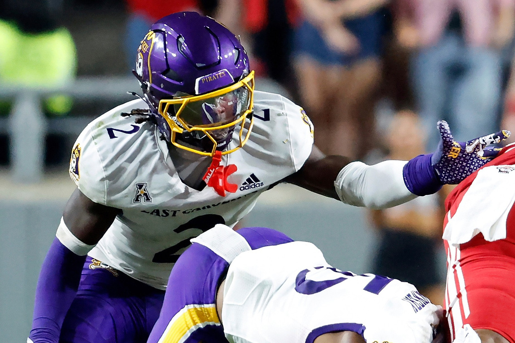 FILE - East Carolina's Ja'Marley Riddle (2) helps with a tackle during the second half of an NCAA college football game against North Carolina State in Raleigh, N.C., Aug. 28, 2025. (AP Photo/Karl DeBlaker, File)