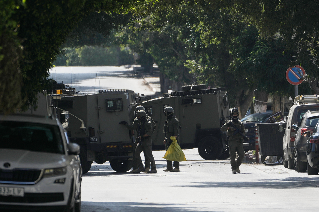 Israeli soldiers move outside the Nablus Speciality Hospital in the West Bank city of Nablus, Friday, July 24, 2026, after Israeli military killed, according to health authorities, at least four Palestinians in the village of Tell in the northern West Bank. (AP Photo/Majdi Mohammed)
