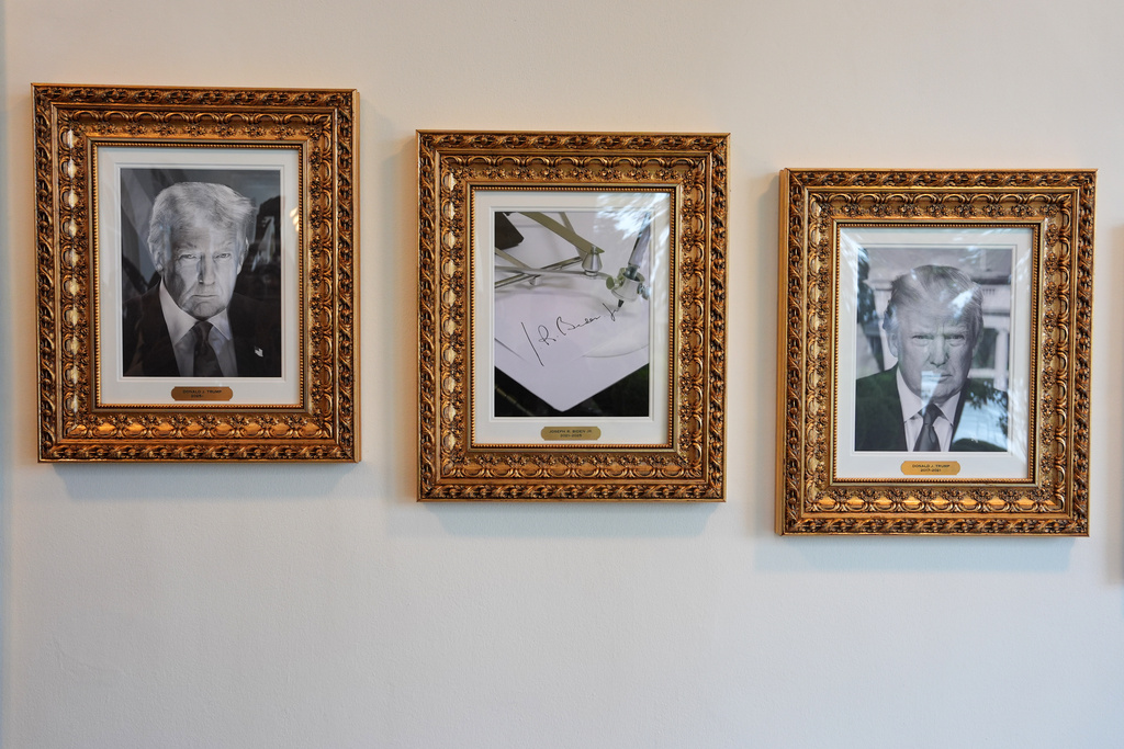Framed images of President Donald Trump and former President Joe Biden's autopen signature, center, appear on the Presidential Walk of Fame on the colonnade of the White House, Thursday, Sept. 25, 2025, in Washington. (AP Photo/Evan Vucci)