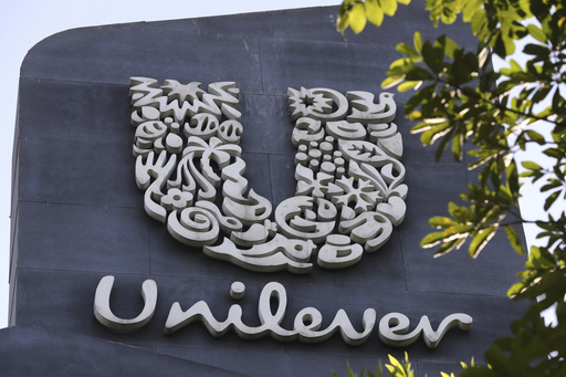 FILE - A Unilever logo is displayed outside the head office of PT Unilever Indonesia Tbk. in Tangerang, Indonesia, Tuesday, Nov. 16, 2021. Unilever, the company that makes Ben &amp; Jerry&rsquo;s ice cream, Dove soaps and Vaseline, says it's cutting 7,500 jobs and spinning off its ice cream business to reduce costs and boost profits. (AP Photo/Tatan Syuflana, File)