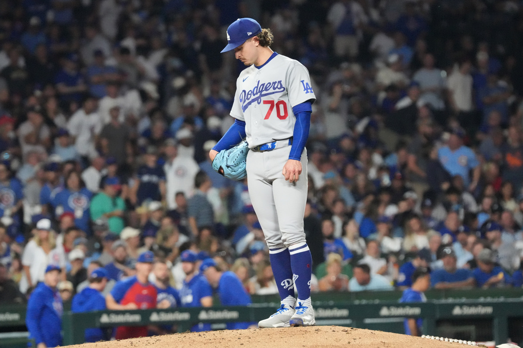 Los Angeles Dodgers pitcher Justin Wrobleski looks down as he is about to leave a baseball game against the Chicago Cubs during the fifth inning Monday, Aug. 3, 2026, in Chicago. (AP Photo/David Banks)
