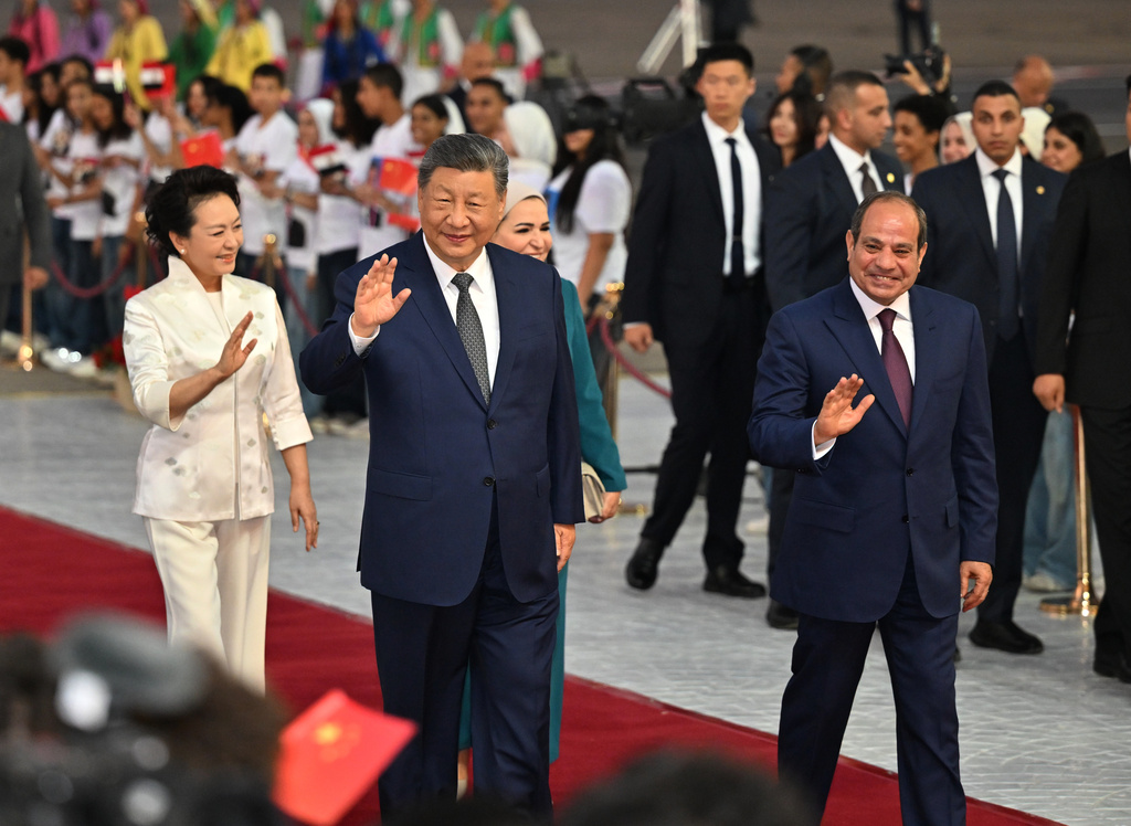 In this photo released by Xinhua News Agency, Chinese President Xi Jinping, second left, and his wife Peng Liyuan, left, are welcomed by Egyptian President Abdel-Fattah el-Sissi, right, and his wife Entissar Amerupon on their arrival at Cairo International Airport in Cairo, Tuesday, Sept. 1, 2026. (Yin Bogu/Xinhua via AP)