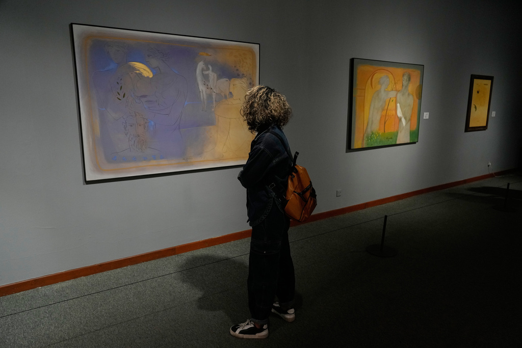 A woman visits an exhibition of work by Iranian artist Bahram Dabiri at the Tehran Museum of Contemporary Art in Iran, Thursday, Nov. 20, 2025. (AP Photo/Vahid Salemi)