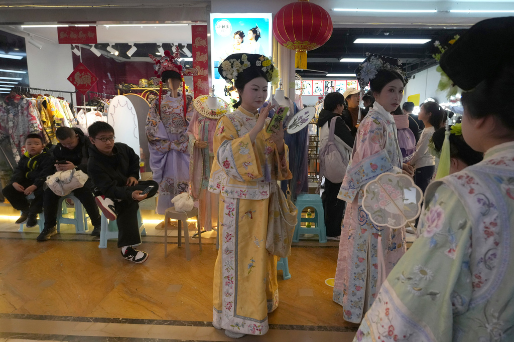 Tourists wear historical Chinese costumes at studios near the Forbidden City in Beijing on Saturday, April 4, 2026. (AP Photo/Ng Han Guan)