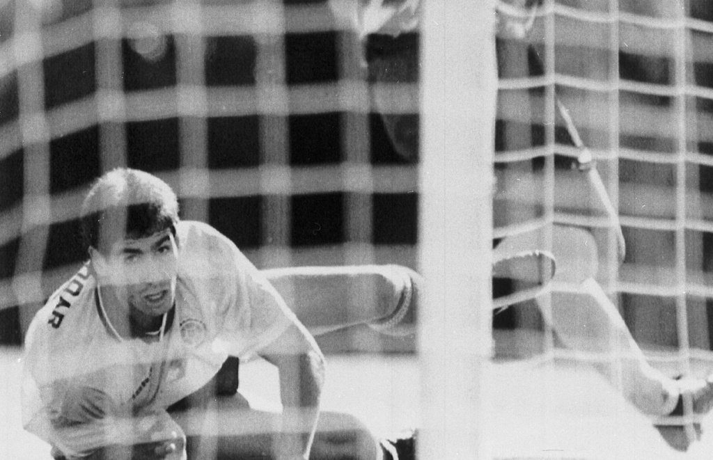 FILE - Colombia's Andres Escobar lies on the ground and watches a shot by America's Eric Wynalda miss the Colombian goal during a World Cup match at the Rose Bowl in Pasadena, Calif., June 22, 1994. (AP Photo/Eric Draper, File)