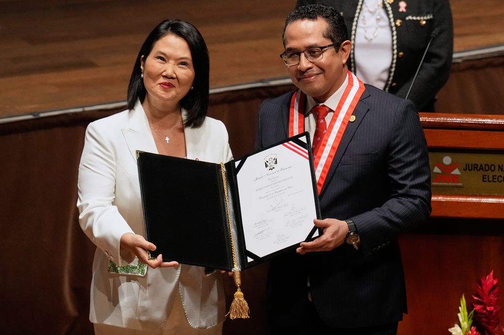 Peru's President-elect Keiko Fujimori, left, receives her credentials from National Elections Board President Roberto Burneo in Lima, Peru, Wednesday, July 15, 2026. (AP Photo/Martin Mejia)