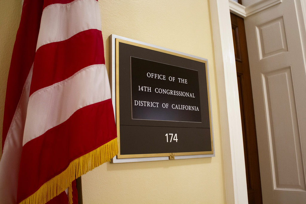 An American flag stands outside the office of California's 14th Congressional District in the Cannon House Office Building in Washington, Monday, July 20, 2026. (AP Photo/Tallulah Brown Van Zee)
