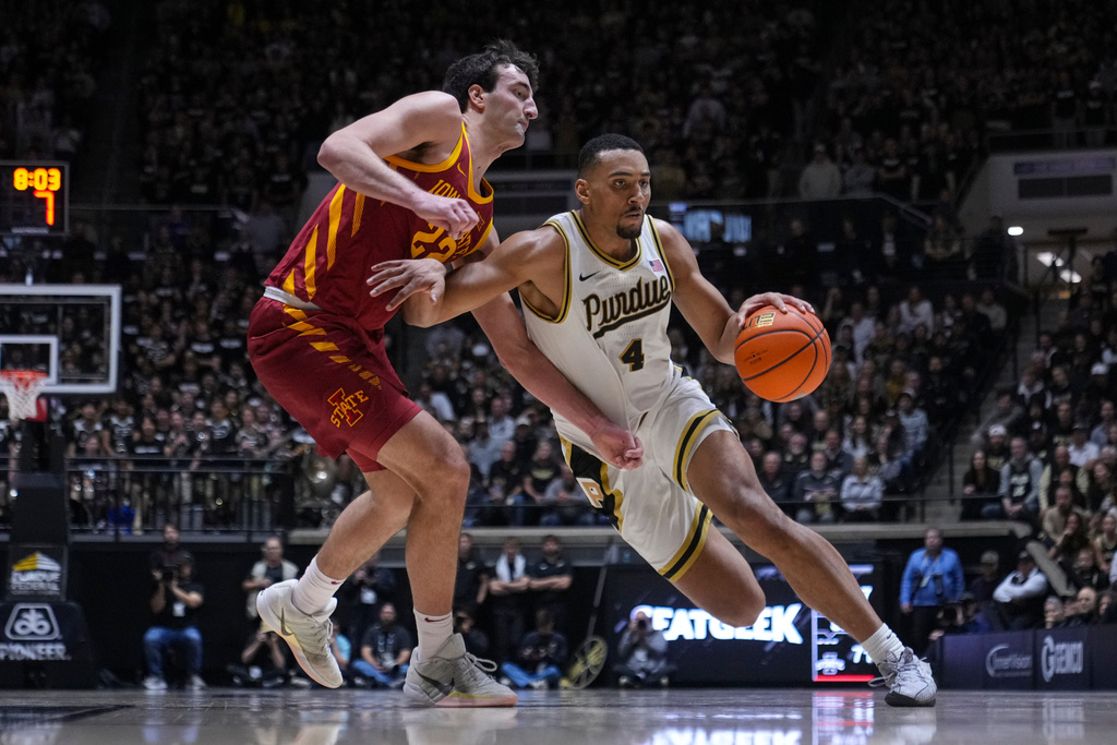 Purdue forward Trey Kaufman-Renn (4) drives on Iowa State forward Milan Momcilovic (22) during the second half of an NCAA college basketball game in West Lafayette, Ind., Saturday, Dec. 6, 2025. (AP Photo/Michael Conroy)