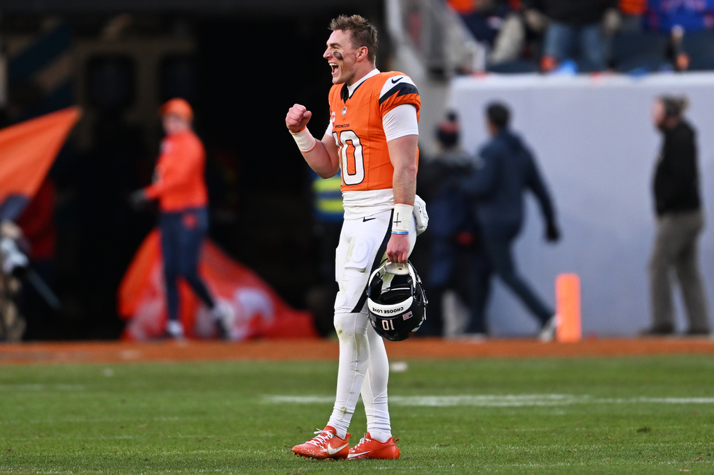 Denver Broncos quarterback Bo Nix (10) celebrates during the first half of an NFL divisional round playoff football game against the Buffalo Bills, Saturday, Jan. 17, 2026, in Denver. (AP Photo/RJ Sangosti)