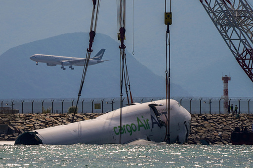 The wreckage of a cargo aircraft that skidded off a runway at the Hong Kong International Airport is prepared for removal on Sunday, Oct. 26, 2025. (AP Photo/Vernon Yuen) The wreckage of a cargo aircraft that skidded off a runway at the Hong Kong International Airport is prepared for removal on Sunday, Oct. 26, 2025. (AP Photo/Vernon Yuen)