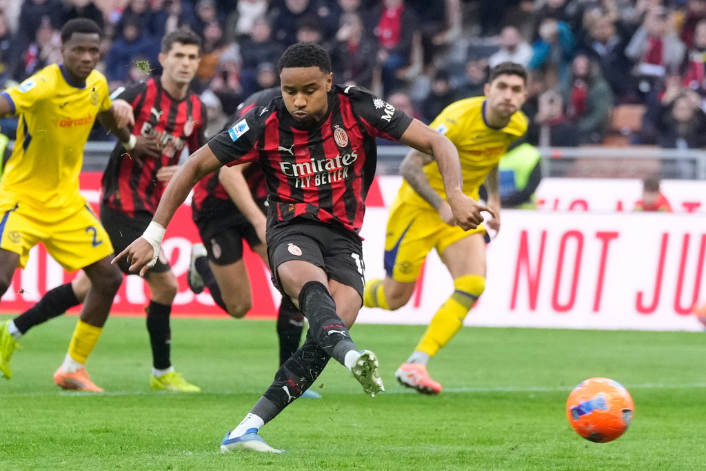 AC Milan's Christopher Nkunku scores his side's second goal from a penalty kick during a Serie A soccer match between AC Milan and Hellas Verona, in Milan, Italy, Sunday, Dec. 28, 2025. (AP Photo/Luca Bruno)