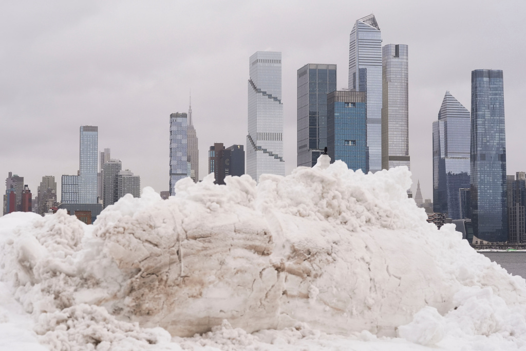 A piece of the New York skyline rises above a pile of snow on the Weekhawken, N.J. waterfront, Monday, Feb. 23, 2026. (AP Photo/Seth Wenig)