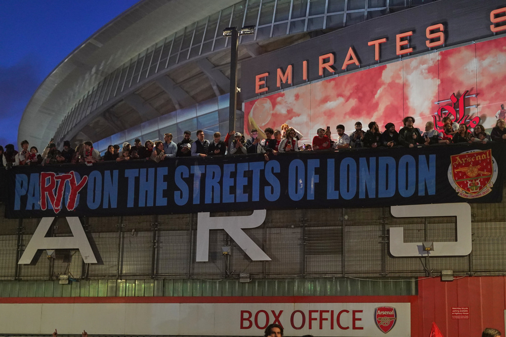 Arsenal supporters gather at the Arsenal stadium after Arsenal's soccer team won the Premier League title in London, Tuesday, May 19, 2026.(AP Photo/Alberto Pezzali)