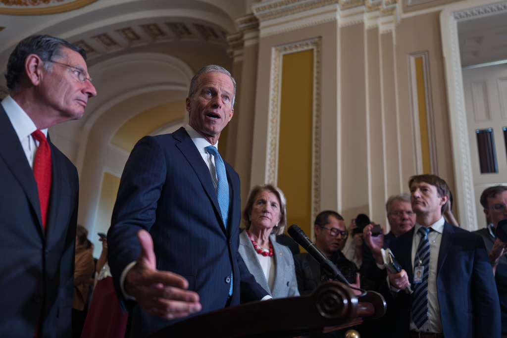 Senate Majority Leader John Thune, R-S.D., flanked by Sen. John Barrasso, R-Wyo., the GOP whip, left, and Sen. Shelly Moore Capito, R-W.Va., as he speaks with reporters after a closed-door GOP meeting at the Capitol in Washington, Wednesday, Nov. 19, 2025. (AP Photo/J. Scott Applewhite)