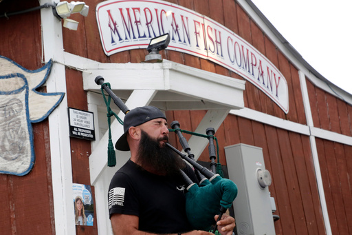 Joey Whitaker from Holden Beach plays "Amazing Grace" on the bagpipes in front of the American Fish Company following a fatal shooting that occurred here the night before, Sunday, Sept. 28, 2025, in Southport, N.C. (AP Photo/Chris Seward) Joey Whitaker from Holden Beach plays "Amazing Grace" on the bagpipes in front of the American Fish Company following a fatal shooting that occurred here the night before, Sunday, Sept. 28, 2025, in Southport, N.C. (AP Photo/Chris Seward)