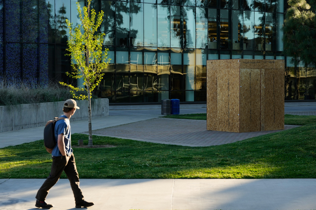 FILE - A student looks toward a plywood box covering a statue of César Chavez at California State University, Fresno in Fresno, Calif., Wednesday, March 18, 2026. (AP Photo/Godofredo A. Vásquez, file)
