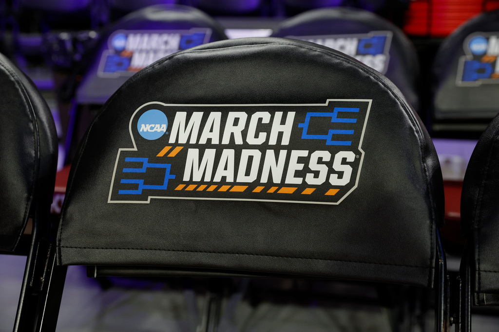 March Madness signage is displayed on chairs before a game between Colorado State and Michigan State in the first round of the NCAA college basketball tournament, Friday, March 20, 2026, Norman, Okla. (AP Photo/Alonzo Adams)