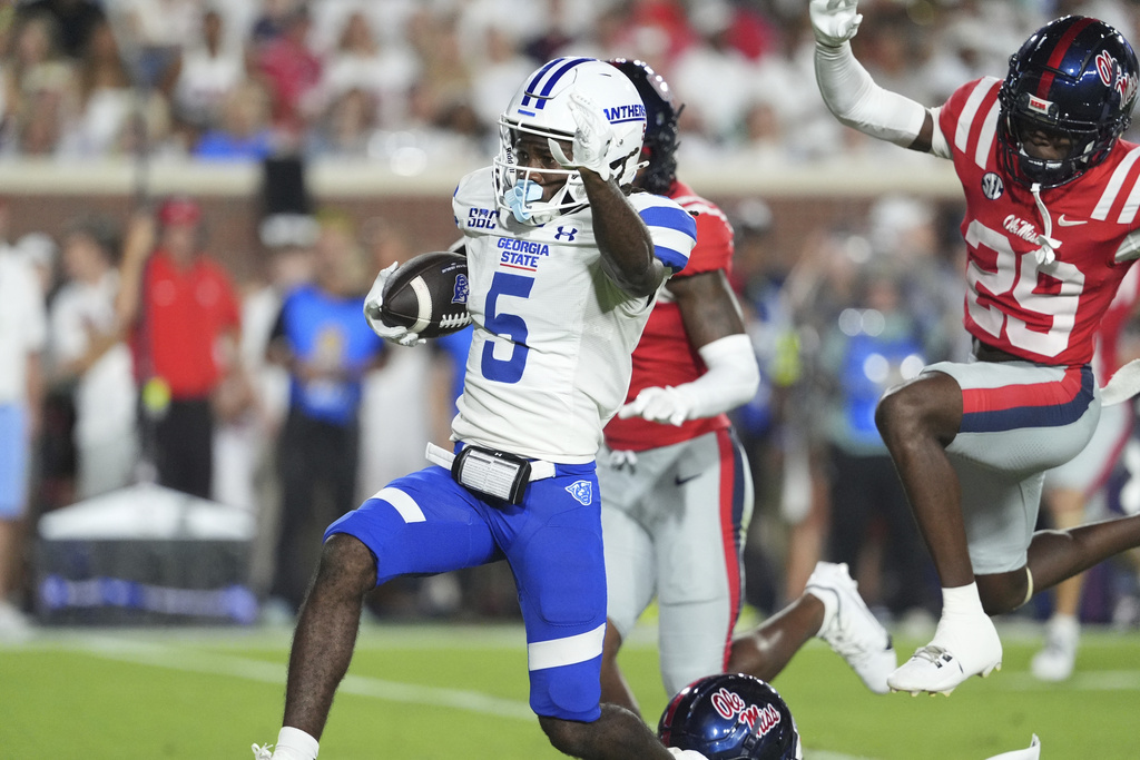 Georgia State wide receiver Javon Robinson (5) leaps past Mississippi safety Nick Cull (29) on his way to a 43-yard touchdown pass reception during the first half of an NCAA college football game in Oxford, Miss., Saturday, Aug. 30, 2025. (AP Photo/Rogelio V. Solis)