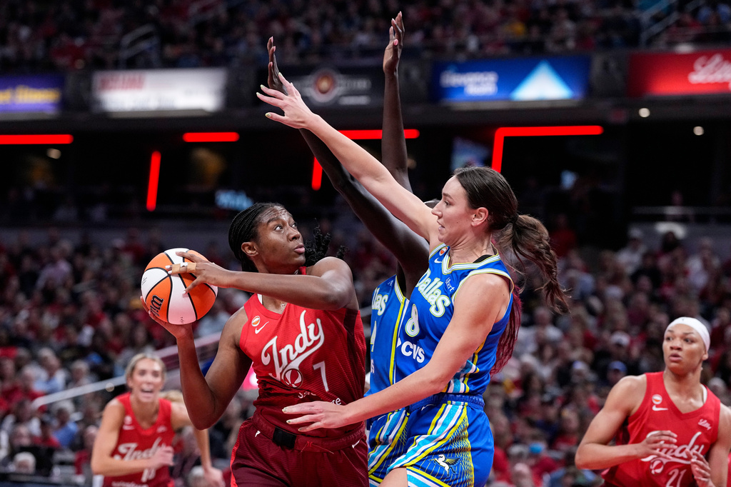 Indiana Fever center Aliyah Boston (7) shoots over Dallas Wings forward Alanna Smith (8) in the first half of a WNBA basketball game in Indianapolis, Friday, Aug. 14, 2026. (AP Photo/Michael Conroy)