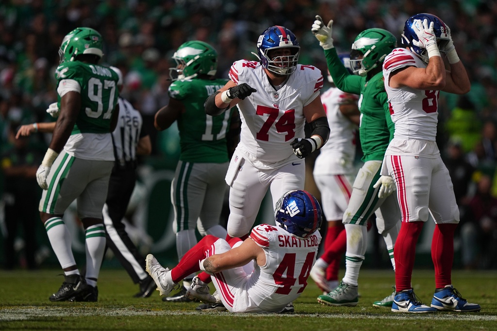 New York Giants running back Cam Skattebo (44) reacts after an injury during the first half of an NFL football game against the Philadelphia Eagles on Sunday, Oct. 26, 2025, in Philadelphia. (AP Photo/Matt Rourke)