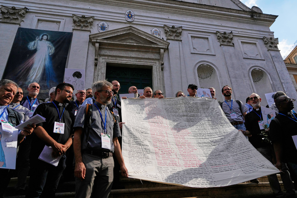 Priests from various countries, members of the "Priests Against Genocide" network, carry a shroud bearing the names of 300 Palestinian and Lebanese children whom organizers say were killed by the Israeli military after ceasefires were declared, during a demonstration near St. Peter's Square at the Vatican, Tuesday, Sept. 22, 2026. (AP Photo/Gregorio Borgia)