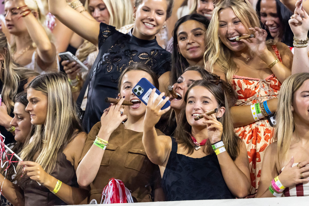 Alabama fans light up cigars, a tradition for the victor of the Tennessee-Alabama game, during the second half of an NCAA college football game, Saturday, Oct. 18, 2025, in Tuscaloosa, Ala. (AP Photo/Vasha Hunt)